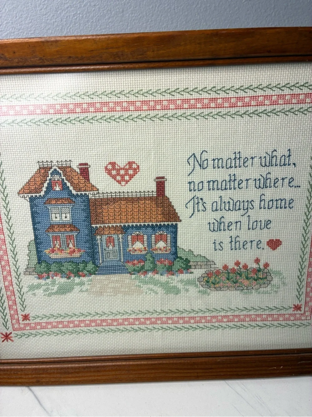 Framed Cross Stitch Home Sampler with Blue House and Quote